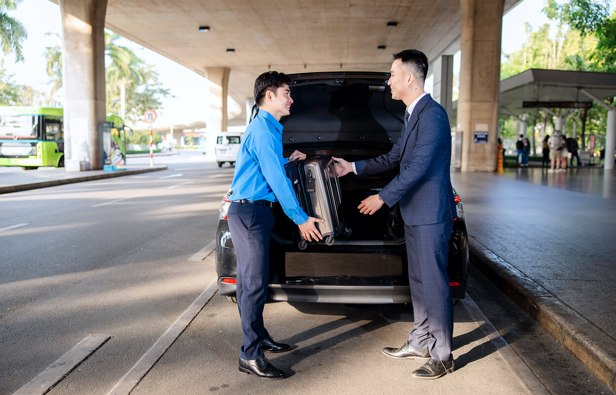 Driver taking a suitcase from a businessman