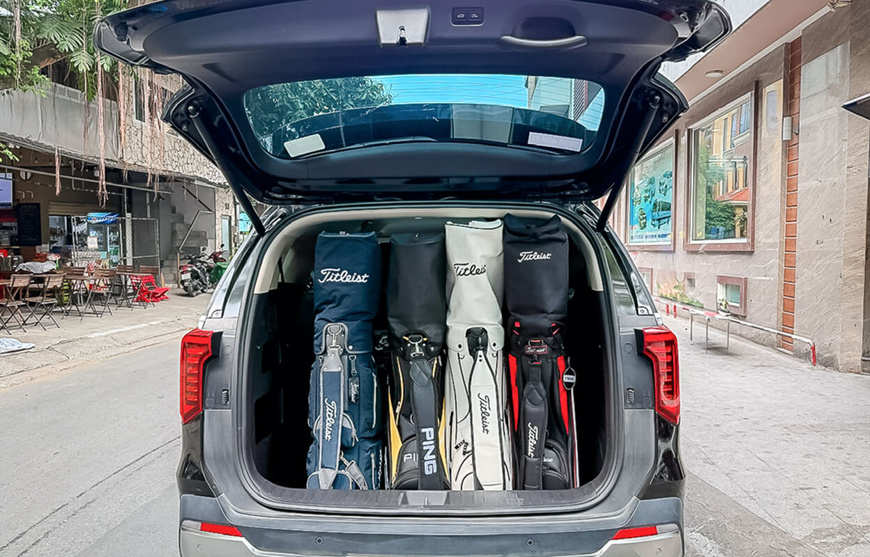 Golf bags standing vertically in the trunk