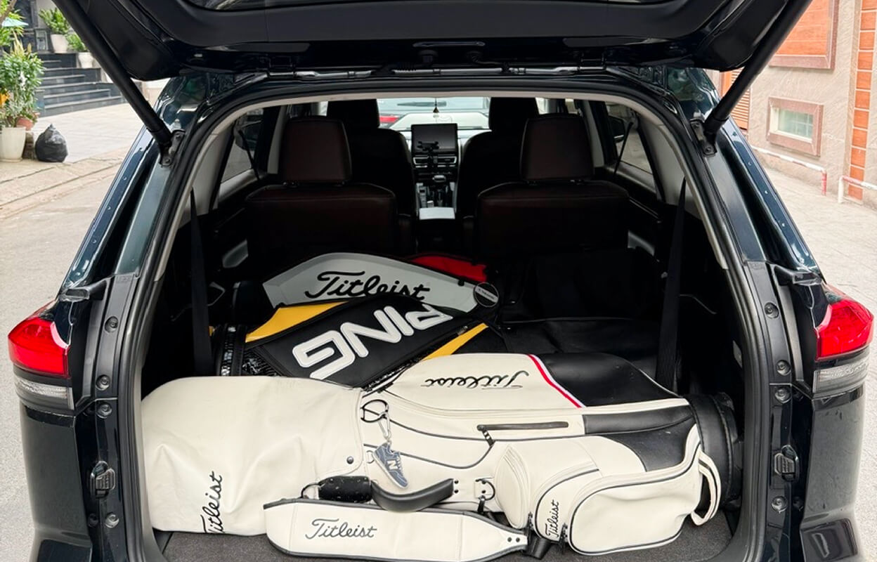 Golf bags lying horizontally in the trunk