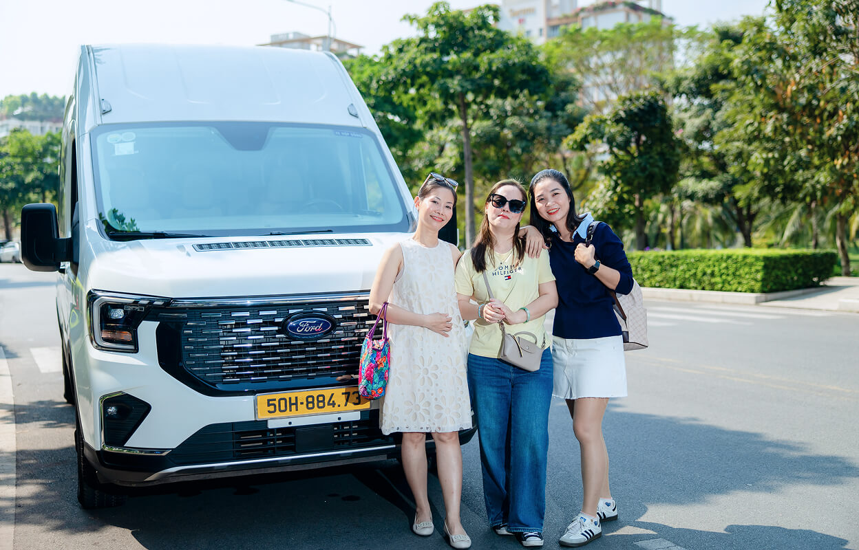Three female tourists with a white van